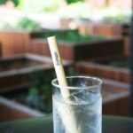 clear drinking glass with white straw